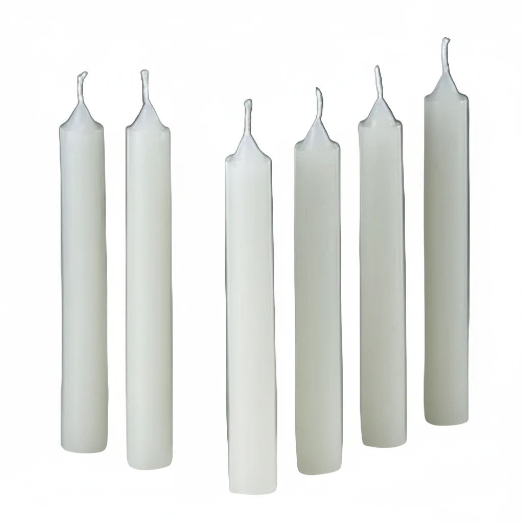 Set of six white candles on a gray background