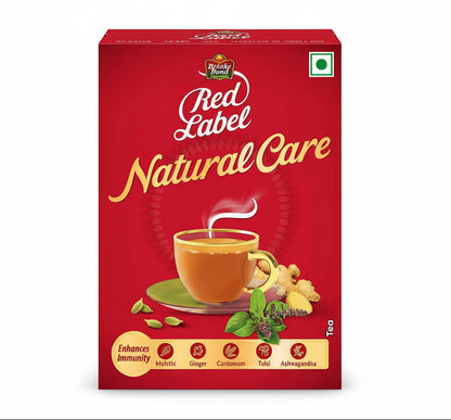 Red Label Natural Care tea packaging with a cup of tea and tea leaves on a red background