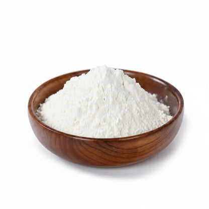 Wooden bowl filled with white powder on a light gray background