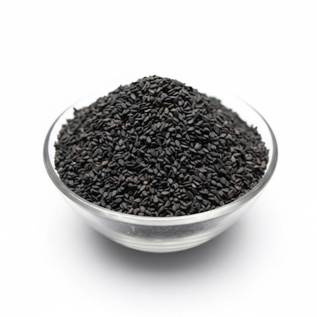 Glass bowl filled with black seeds on a white background