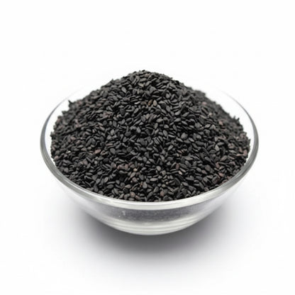 Glass bowl filled with black seeds on a white background
